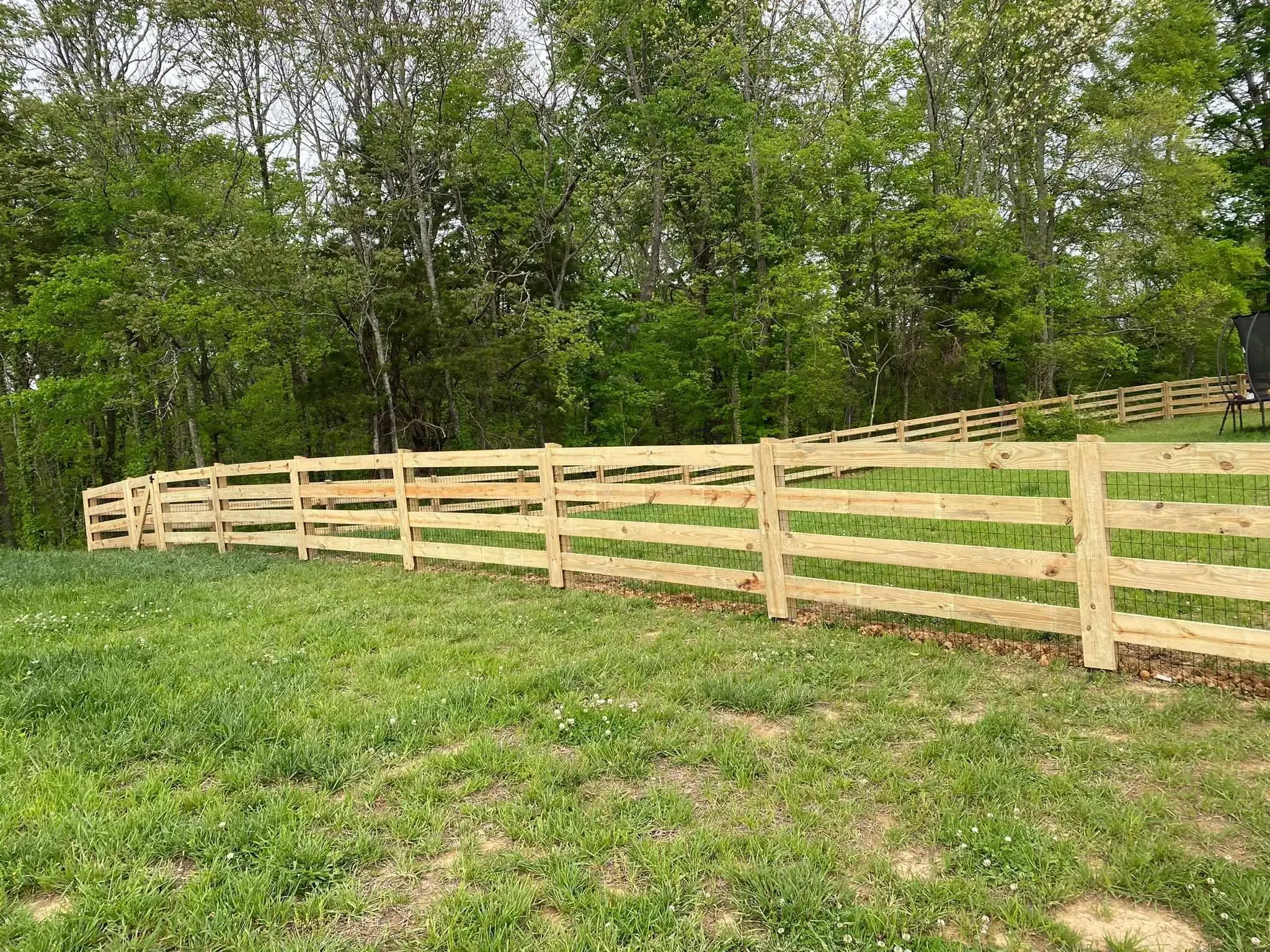 wood ranch rail fence installed by top rail fence
