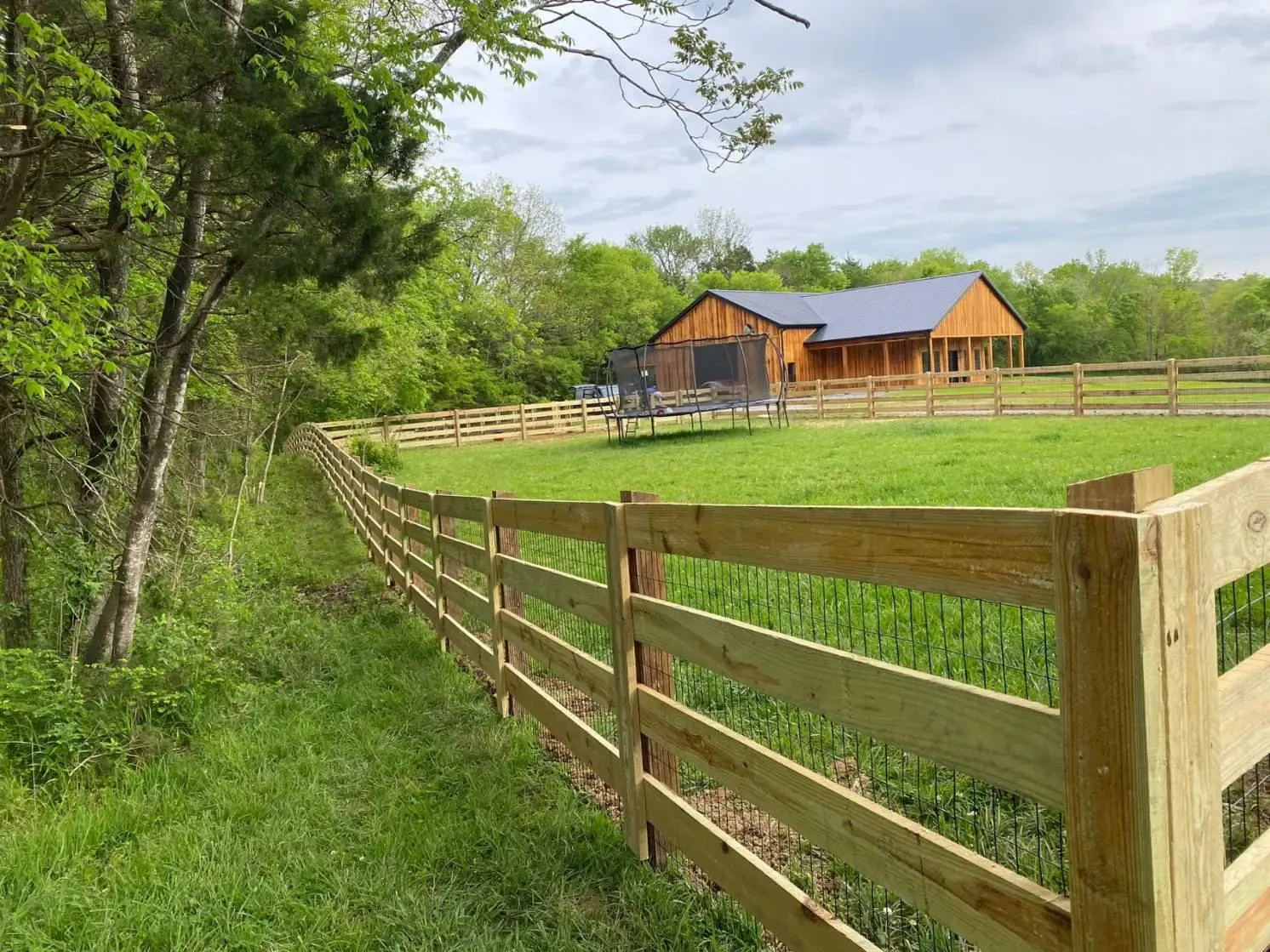 wood ranch rail fence installed by top rail fence