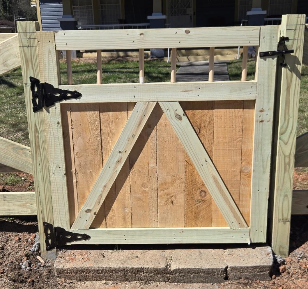 wood gate installed by top rail fence atlanta