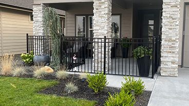 A front porch with a metal fence