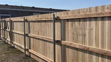 A wooden fence with metal poles