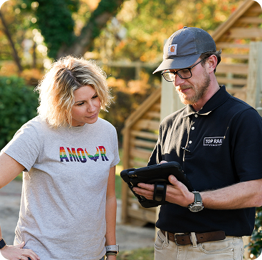 Top Rail employee reviewing a service plan with a customer and pointing to details together