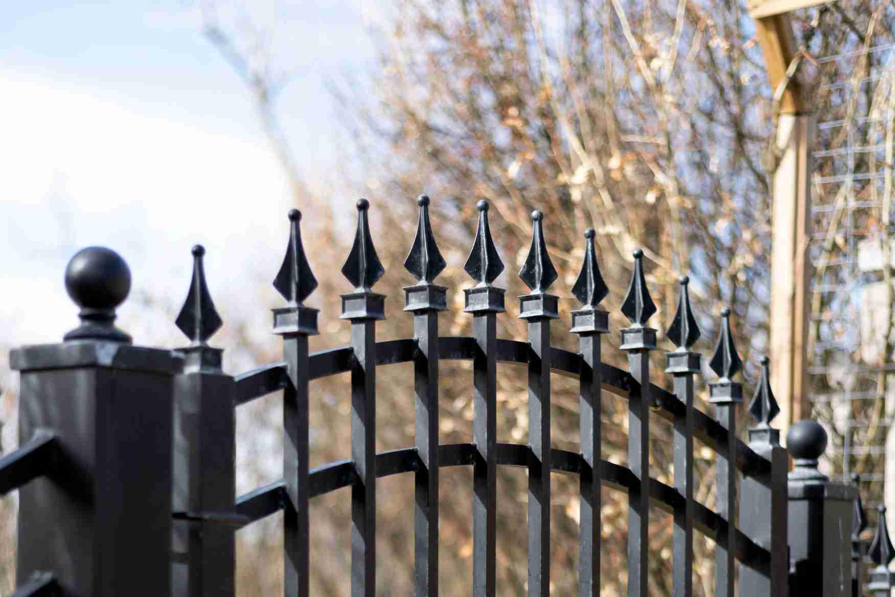 Staggered spear picket metal fence by Top Rail Fence