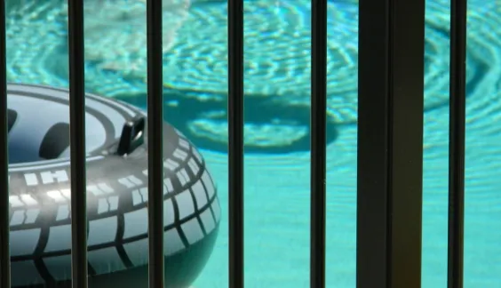 close up of a pool and steel fence