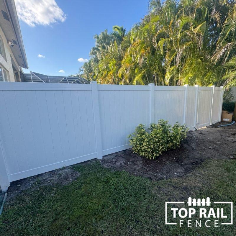 white vinyl fence installation by Top Rail Fence