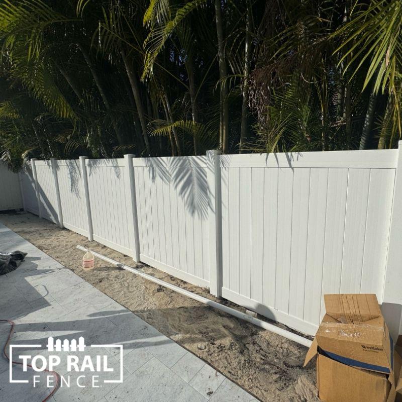 white vinyl fence installation by Top Rail Fence