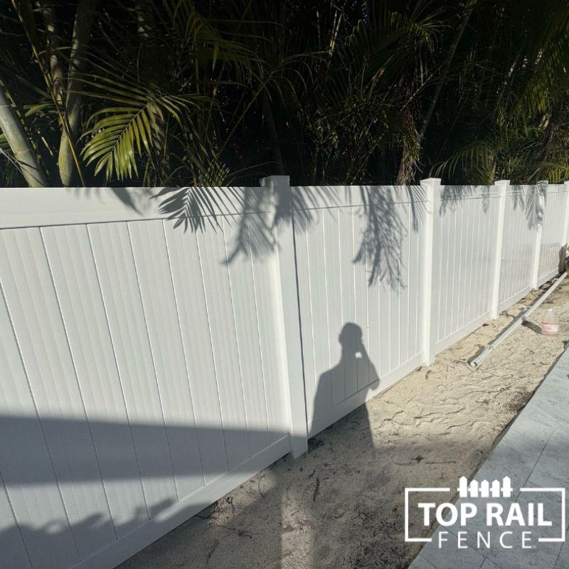 white vinyl fence installation by Top Rail Fence