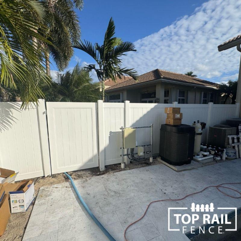 white vinyl fence installation by Top Rail Fence