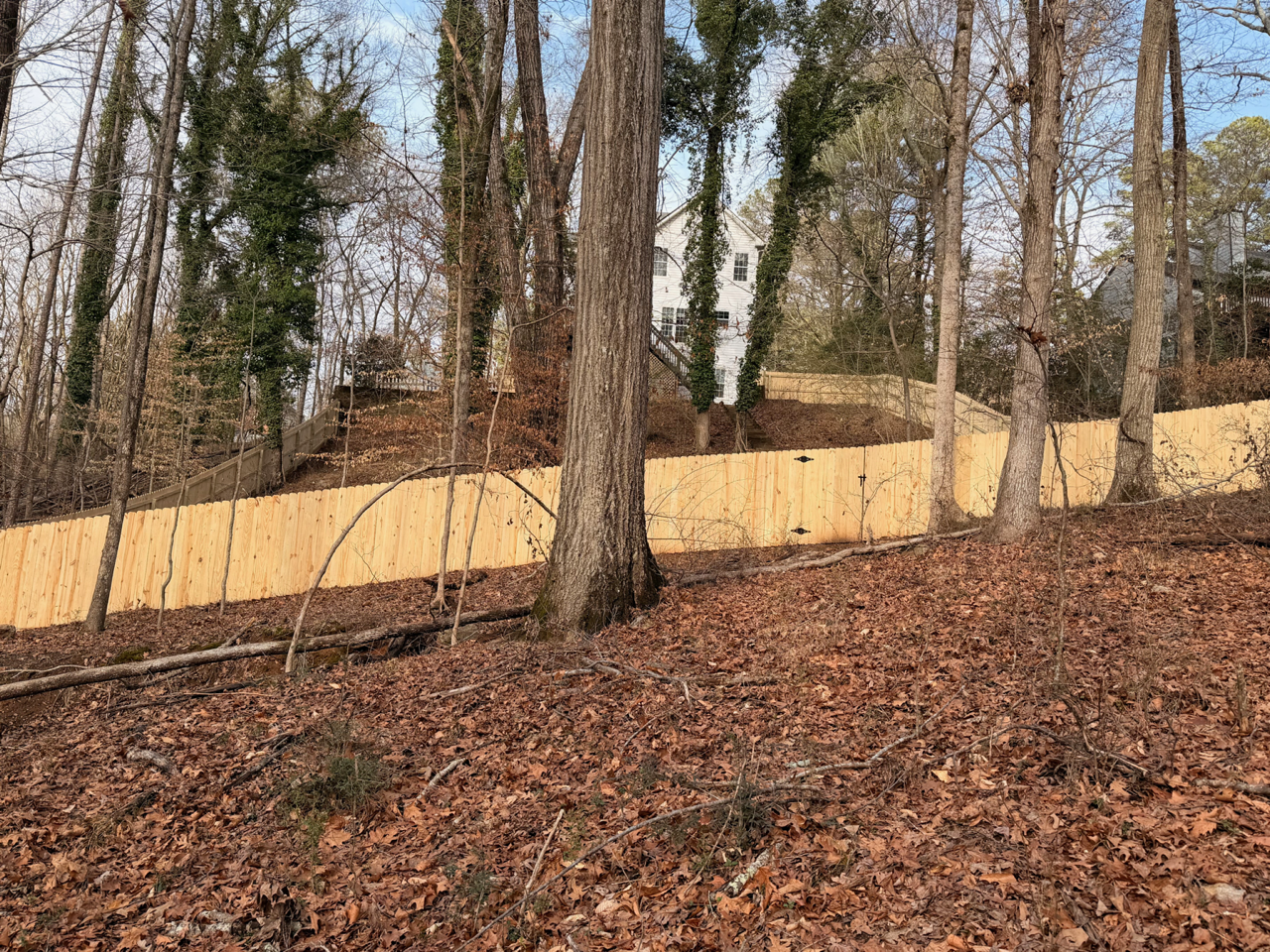 Wood Stockade Fence Installed on Steep Terrain