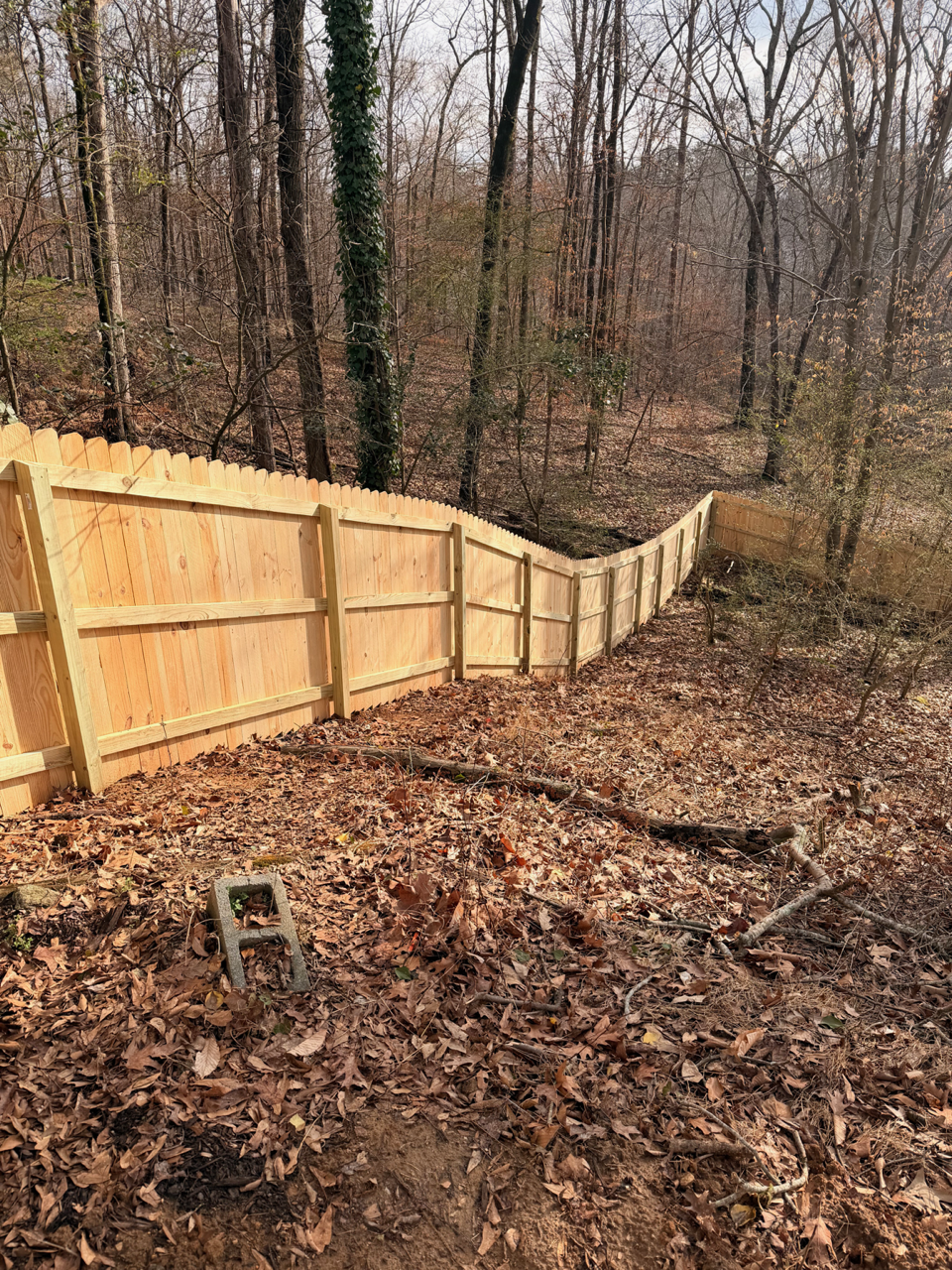wood stockade fence installed by top rail fence