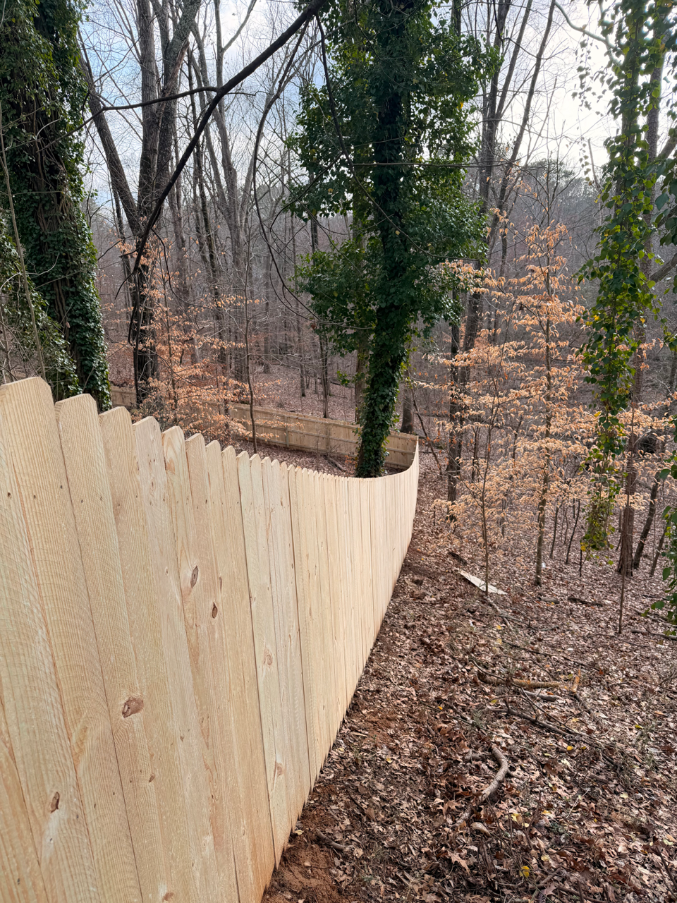 wood stockade fence installed by top rail fence