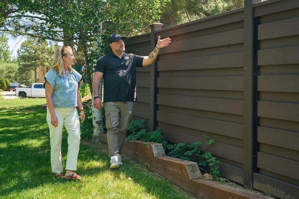 composite fence with people standing in front of it