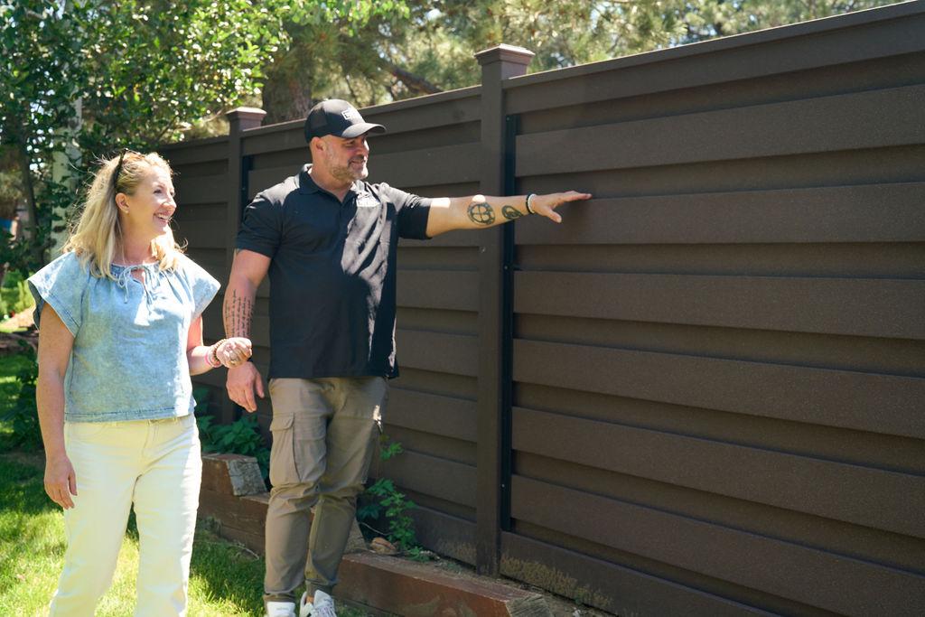 composite fence with people standing in front of it