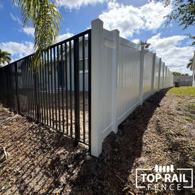 Aluminum and vinyl fence install by Top Rail Fence