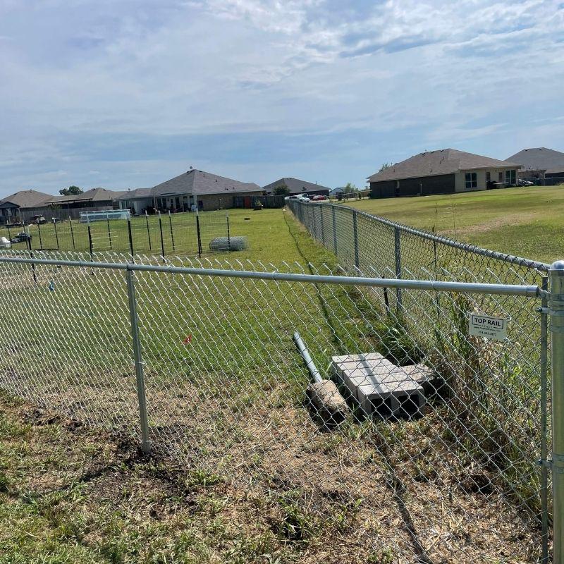chain link fence installed by top rail fence