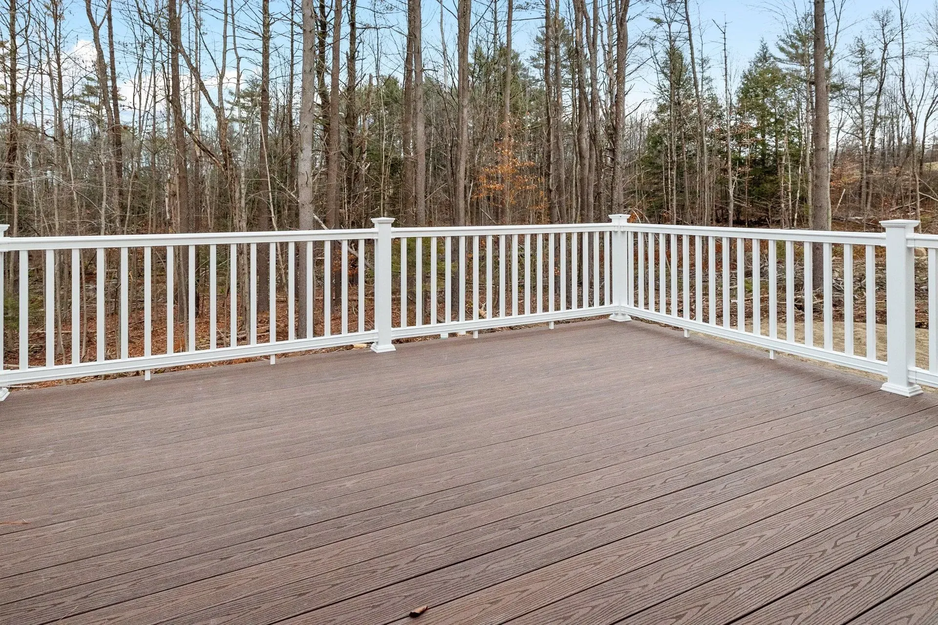 Wooden porch with white fence.