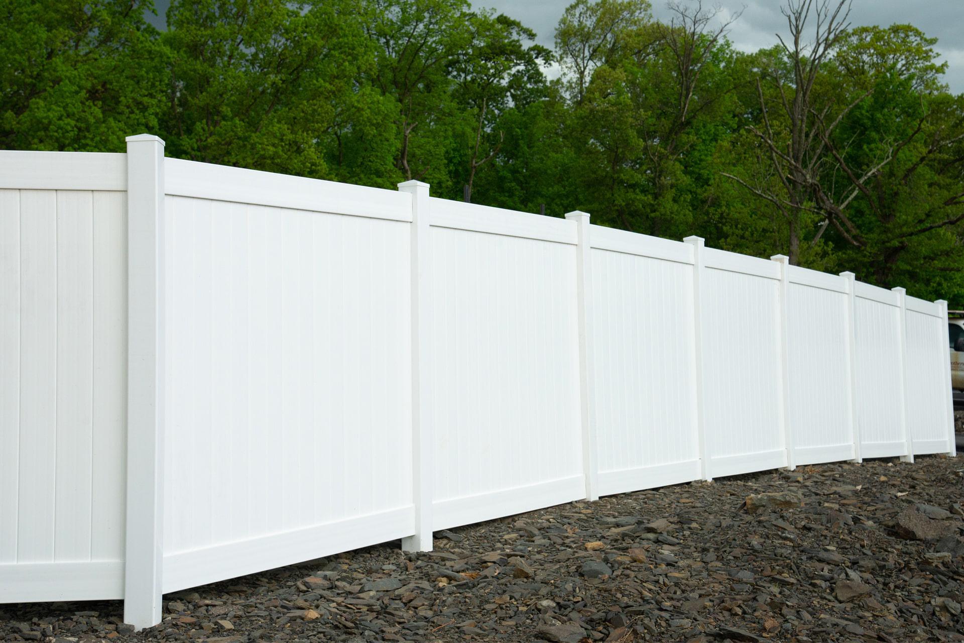 Solid privacy vinyl fence by Top Rail Fence