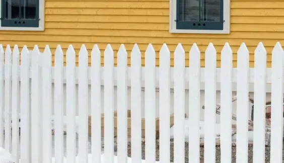 Straight picket vinyl fence by Top Rail Fence