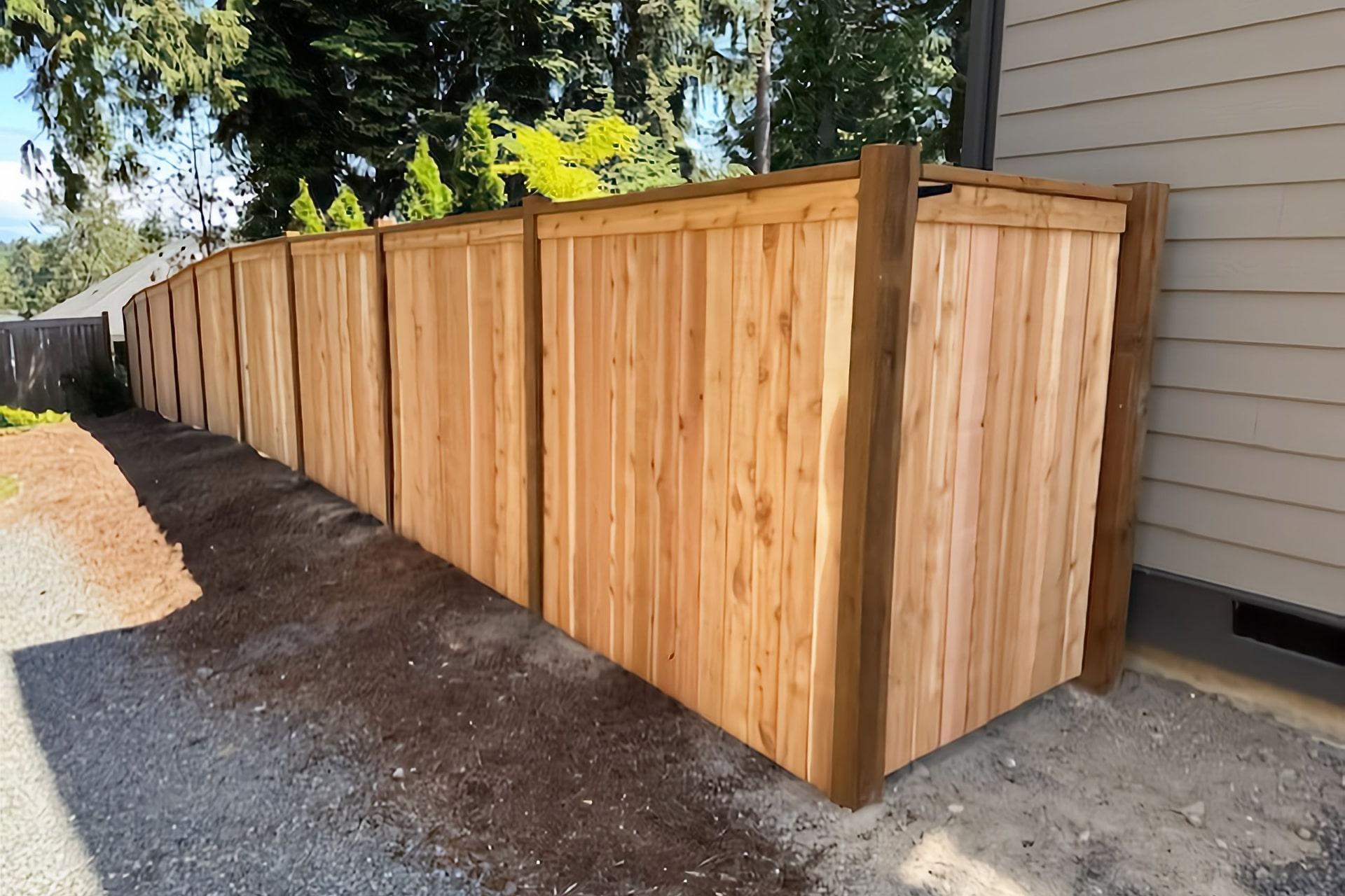Cap and trim wood fence by Top Rail Fence