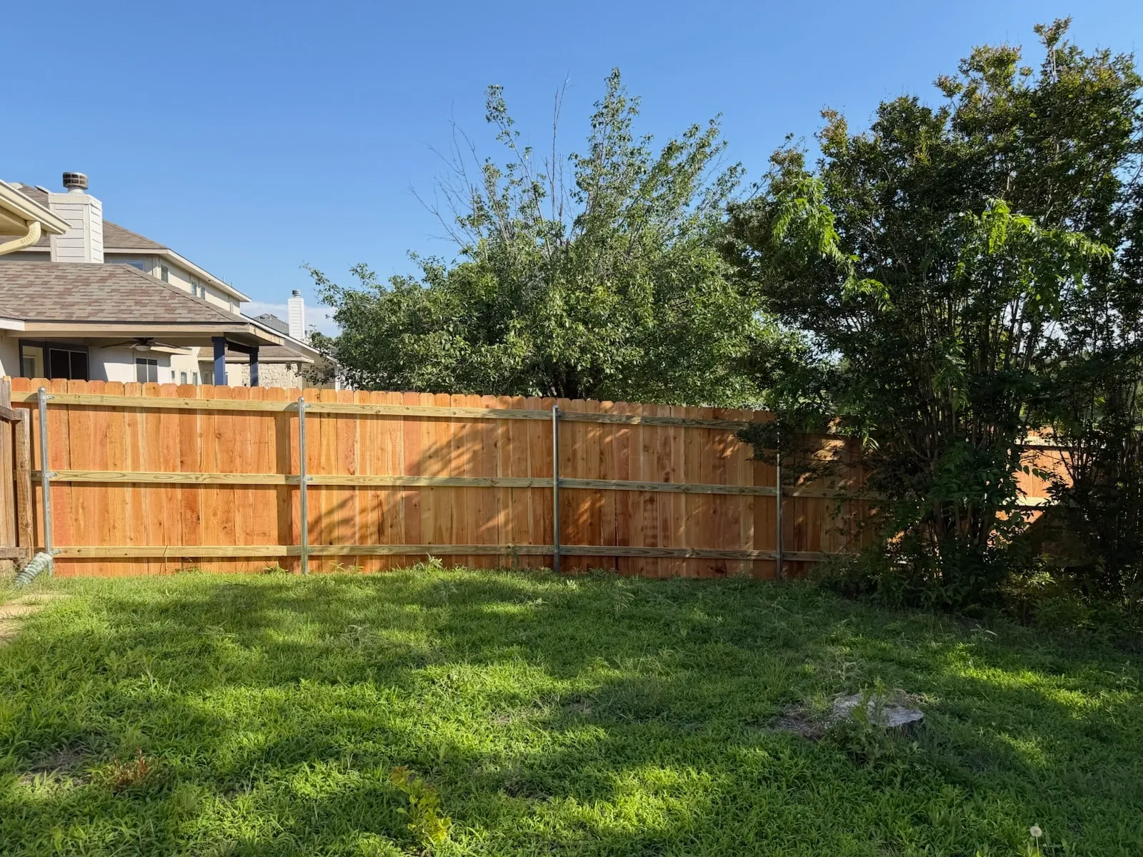 wood stockade fence installed by top rail fence