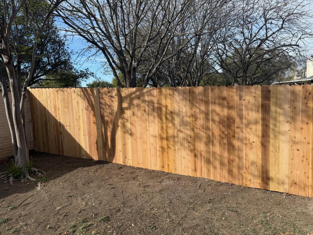 wood stockade fence installed by top rail fence
