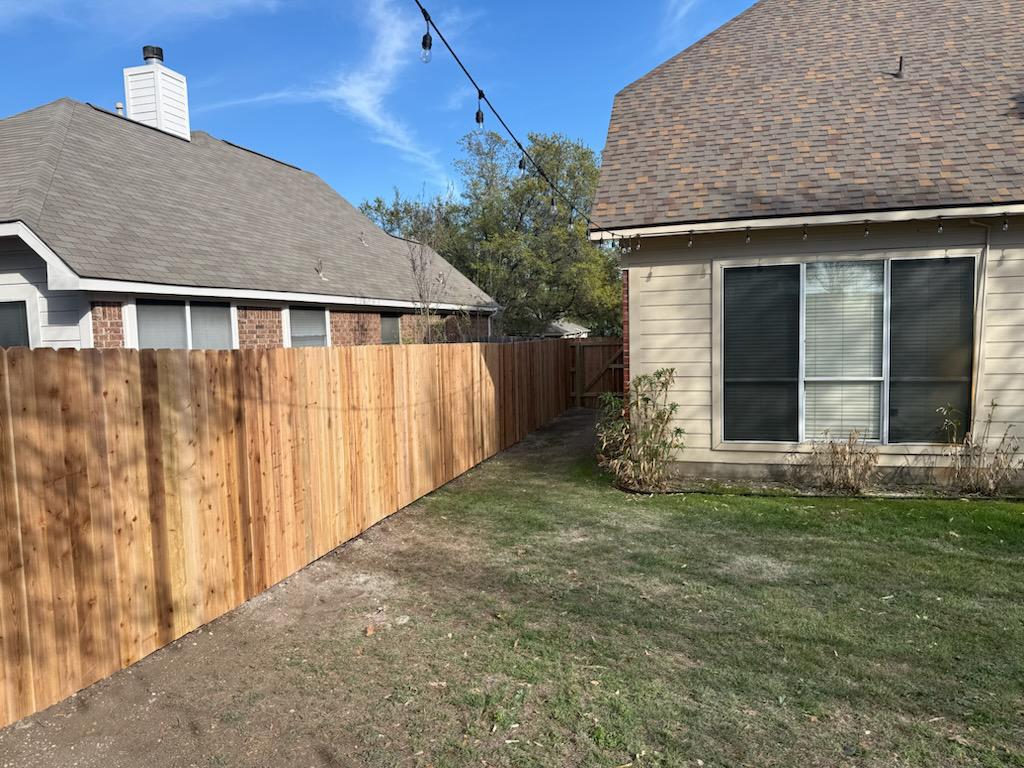 wood stockade fence installed by top rail fence