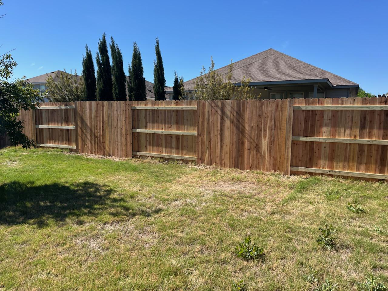 wood stockade fence installed by top rail fence