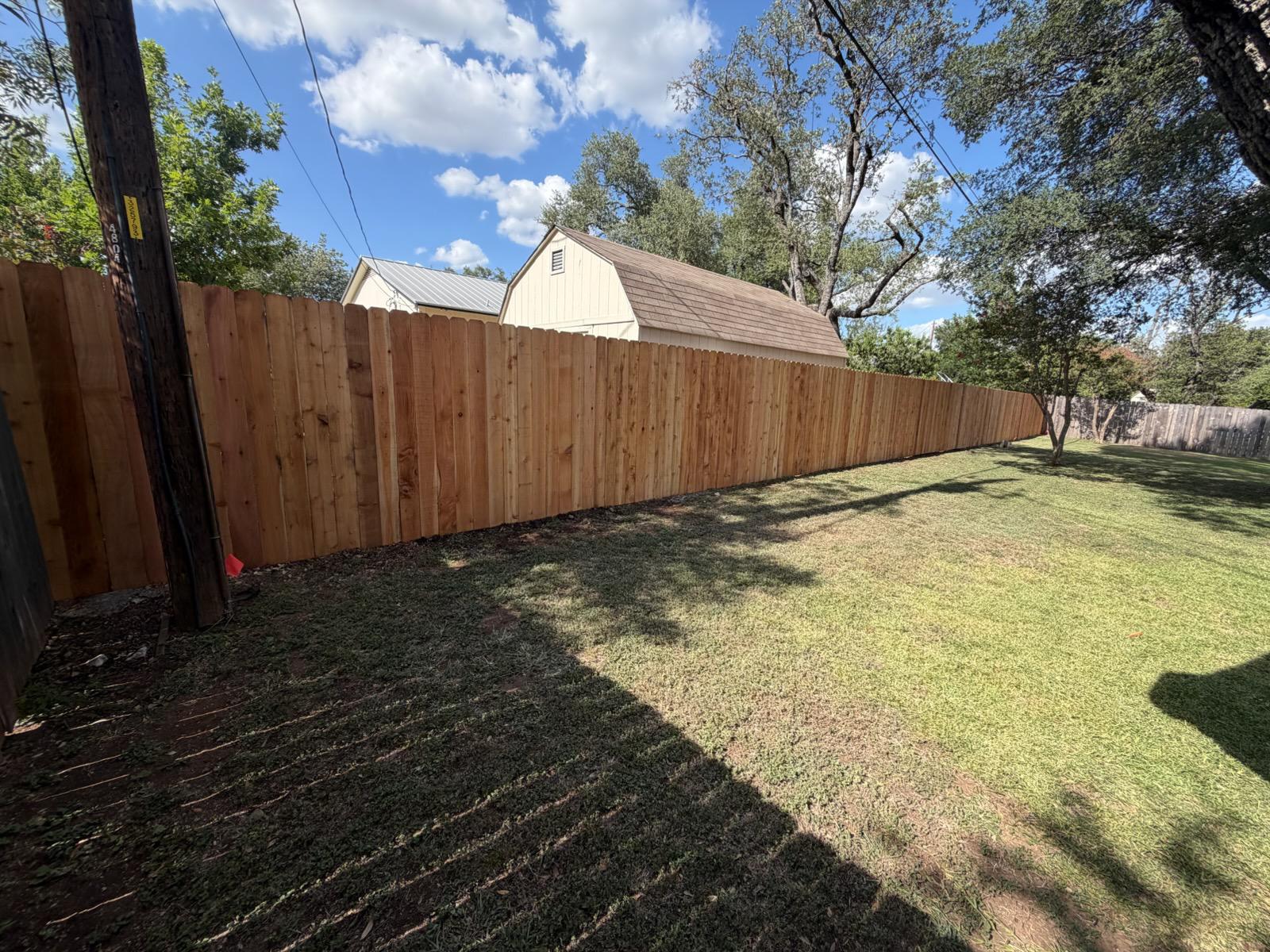 wood stockade fence installed by top rail fence