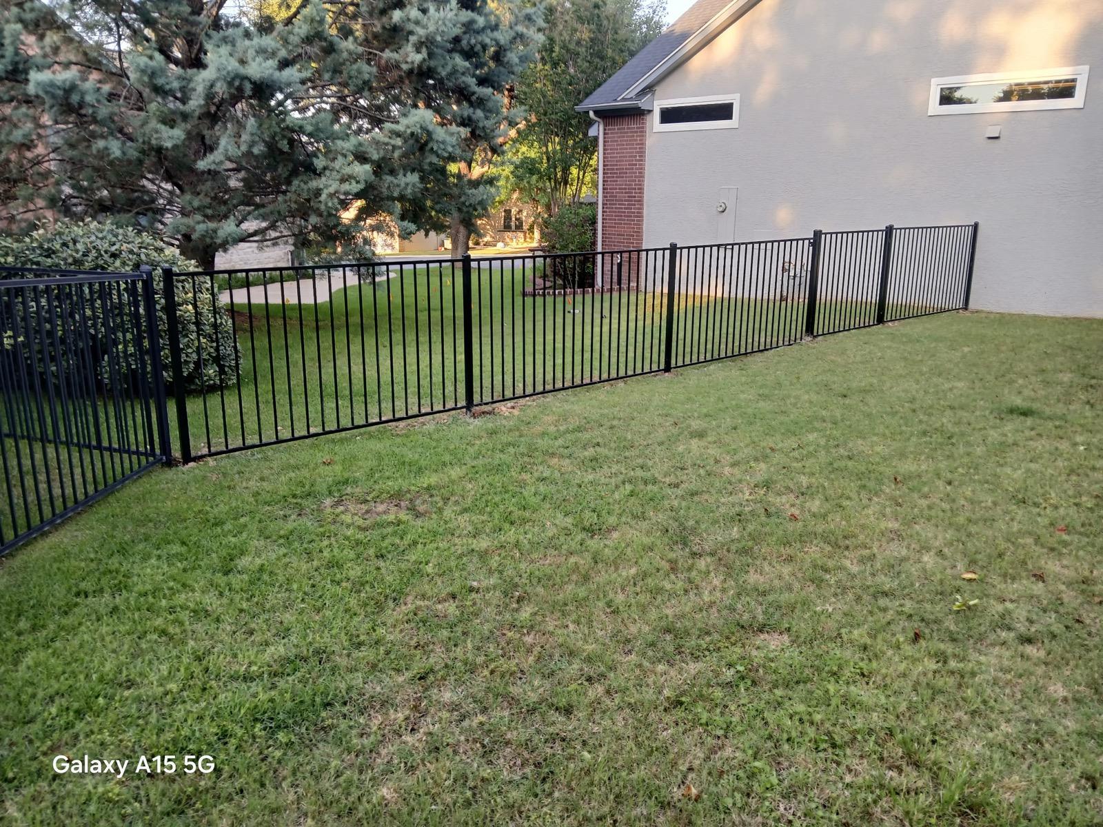 ornamental metal two rail fence installed by top rail fence