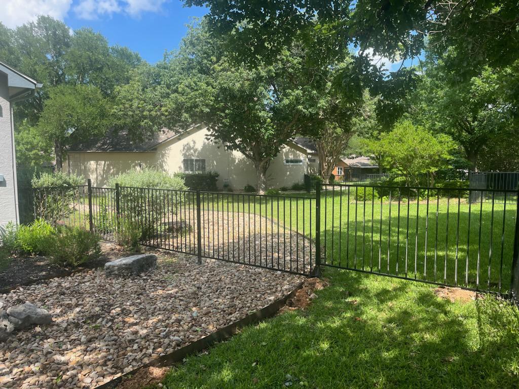ornamental metal two rail fence installed by top rail fence