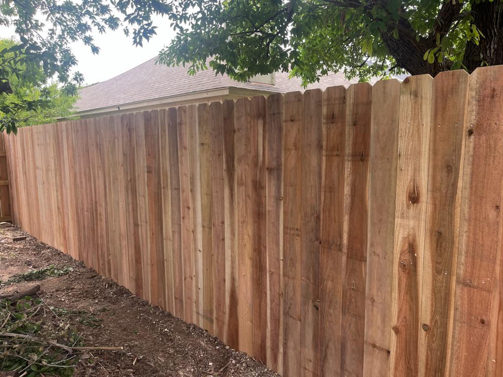 wood stockade fence installed by top rail fence