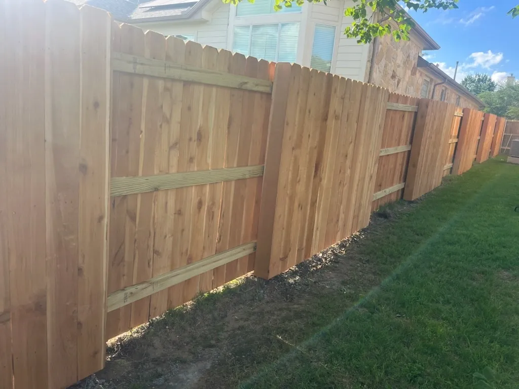 wood good neighbor fence installed by top rail fence