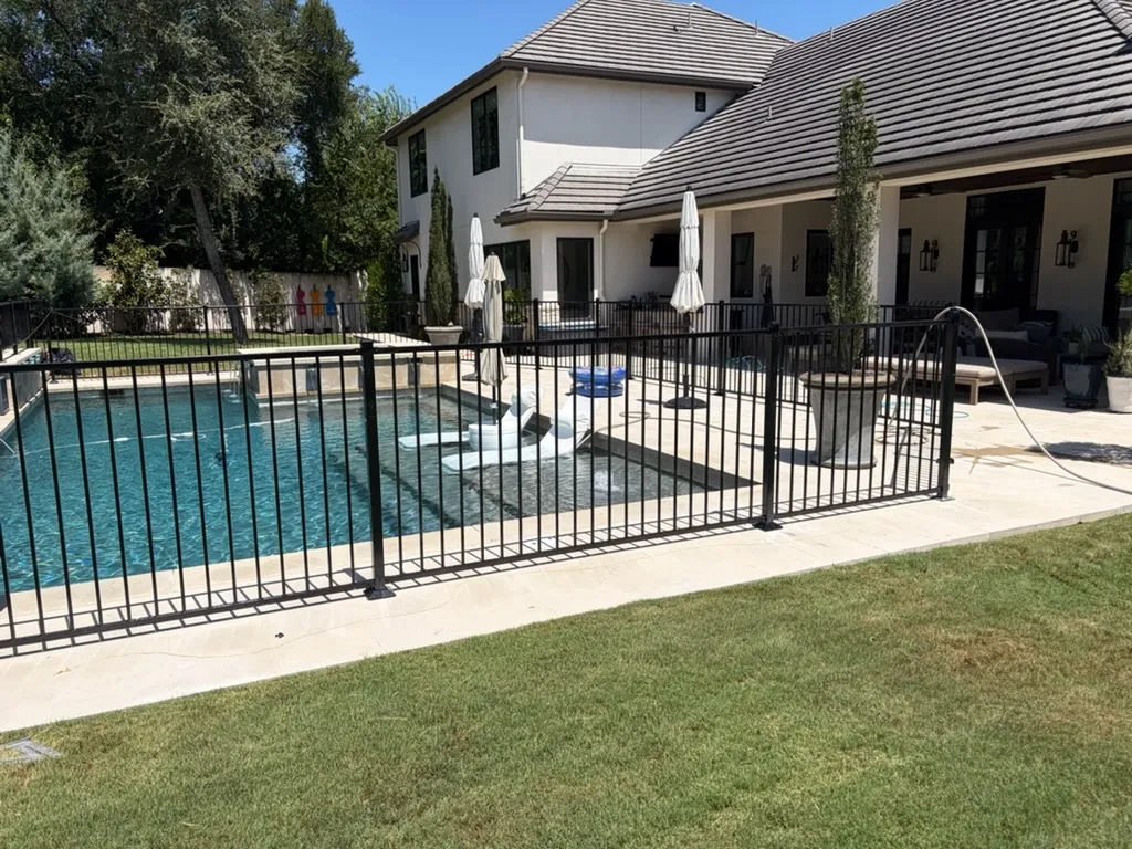 two rail ornamental metal fence installed by top rail fence