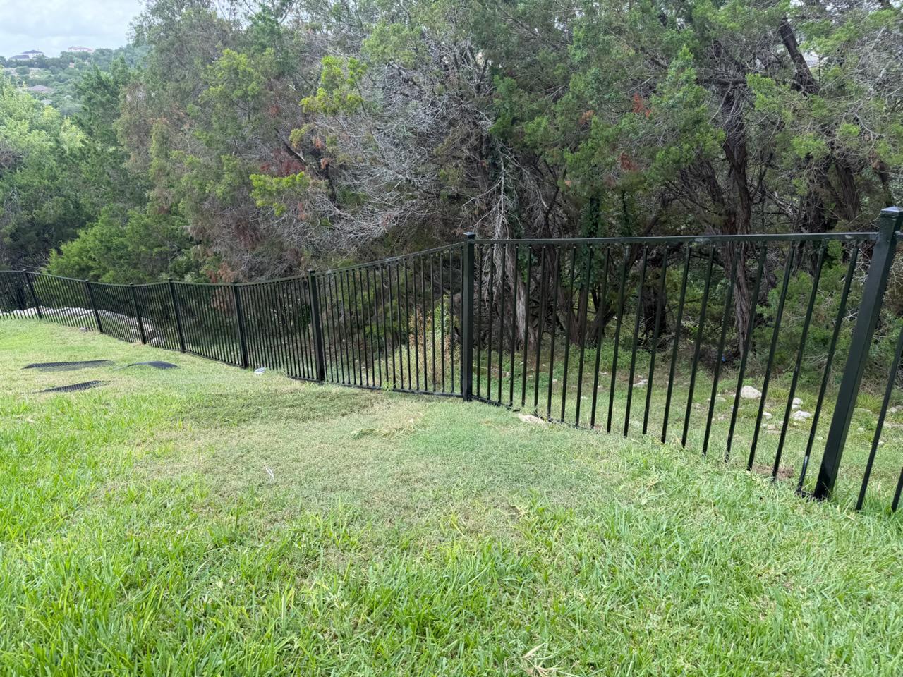 two rail ornamental metal fence installed by top rail fence