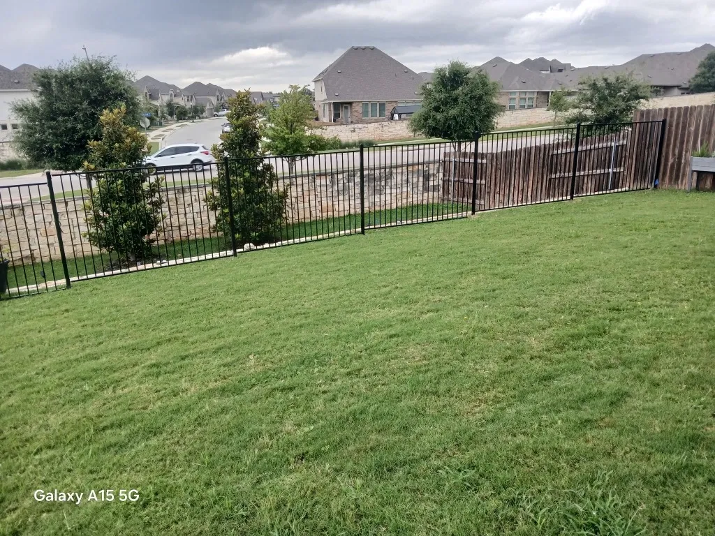 two rail ornamental metal fence installed by top rail fence