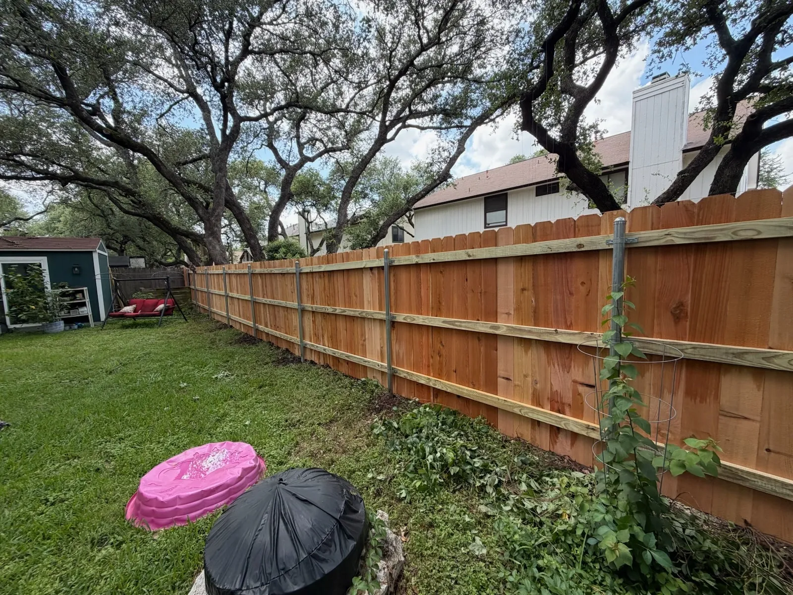 wood stockade fence installed by top rail fence