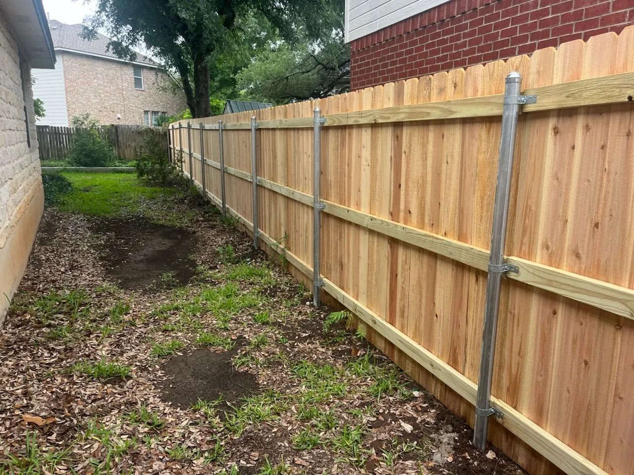 wood stockade fence installed by top rail fence