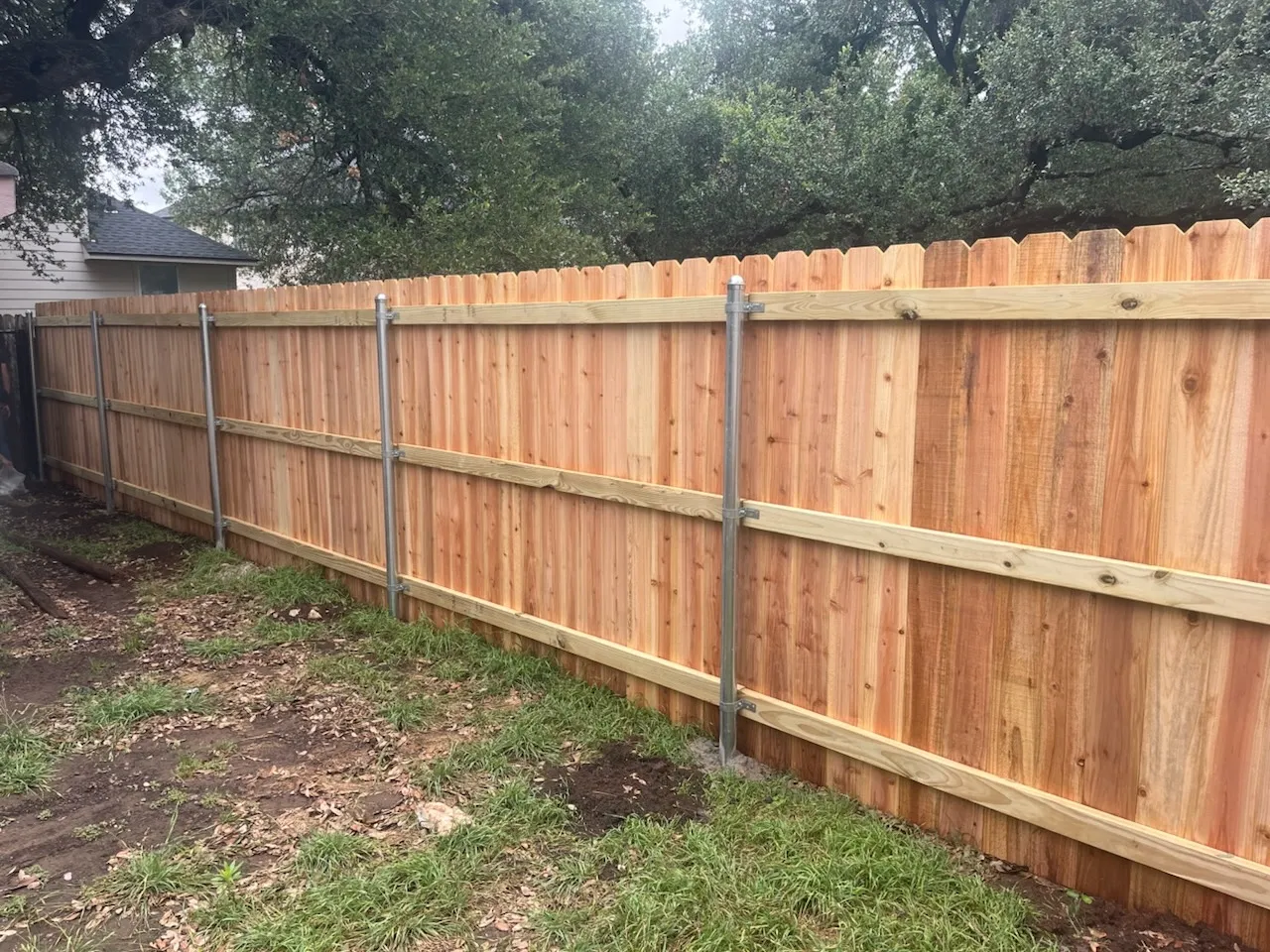 wood stockade fence installed by top rail fence