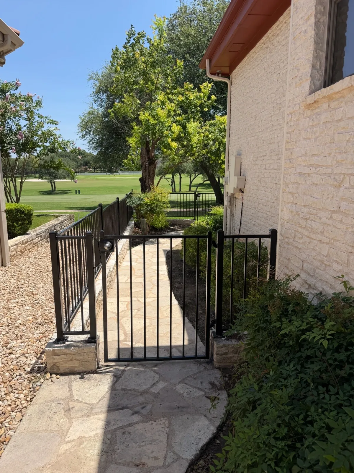 two rail ornamental metal gate installed by top rail fence