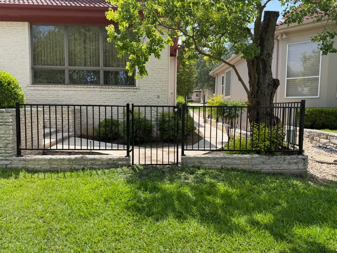 two rail ornamental metal fence installed by top rail fence 
