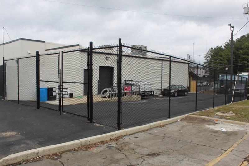 black chain link fence installed by top rail fence