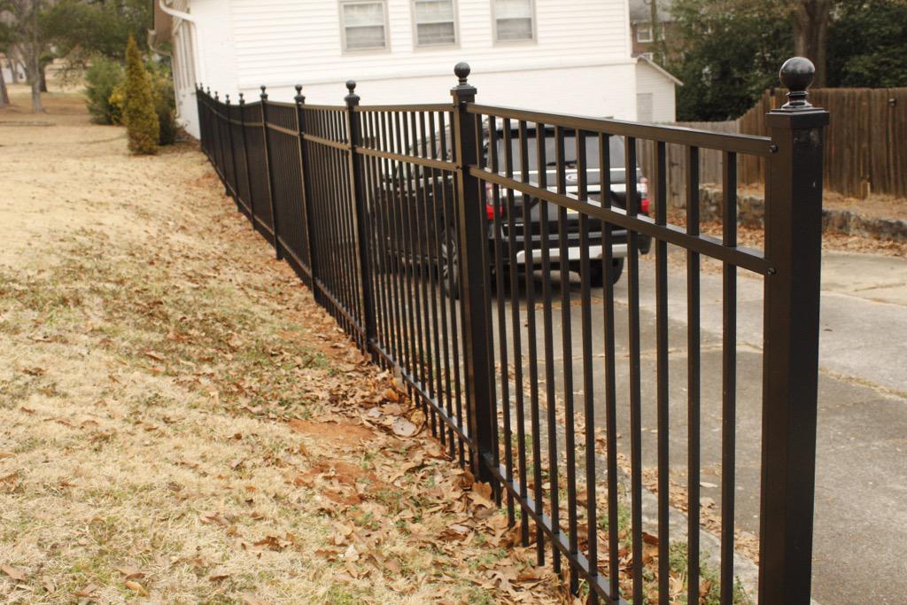three rail ornamental metal fence installed by top rail fence