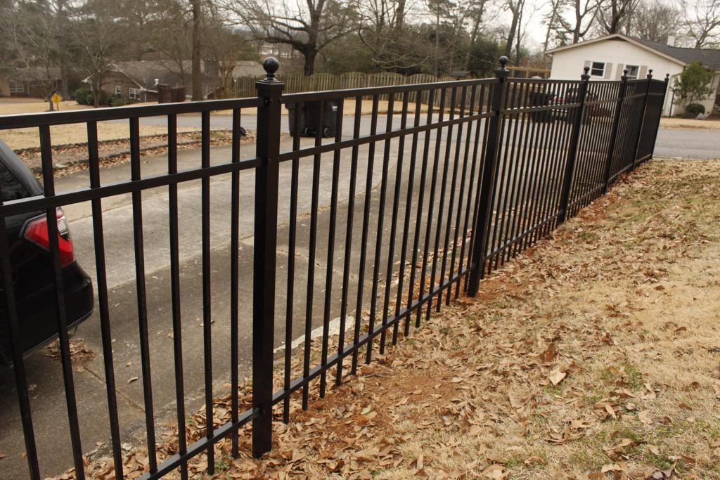 three rail ornamental metal fence installed by top rail fence