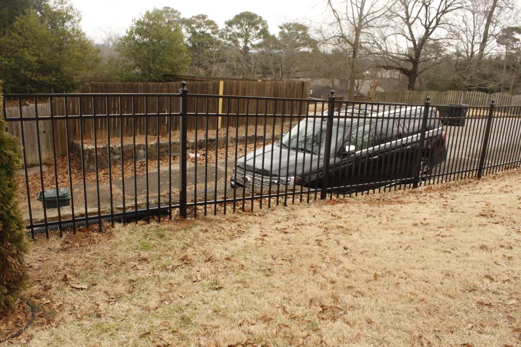 three rail ornamental metal fence installed by top rail fence