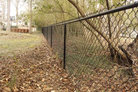 black chain link fence installed by top rail fence