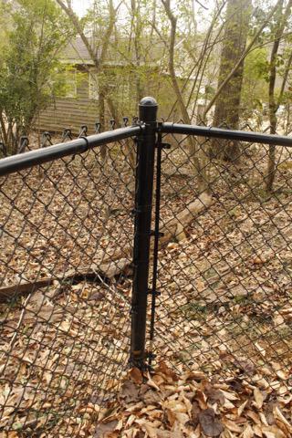 black chain link fence installed by top rail fence