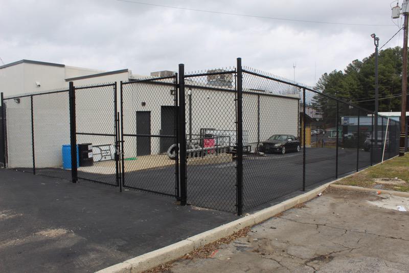 black chain link fence installed by top rail fence