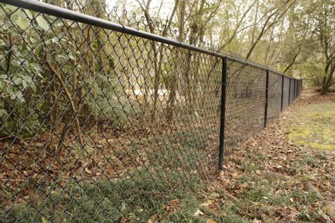 black chain link fence installed by top rail fence