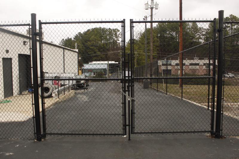 black chain link fence installed by top rail fence