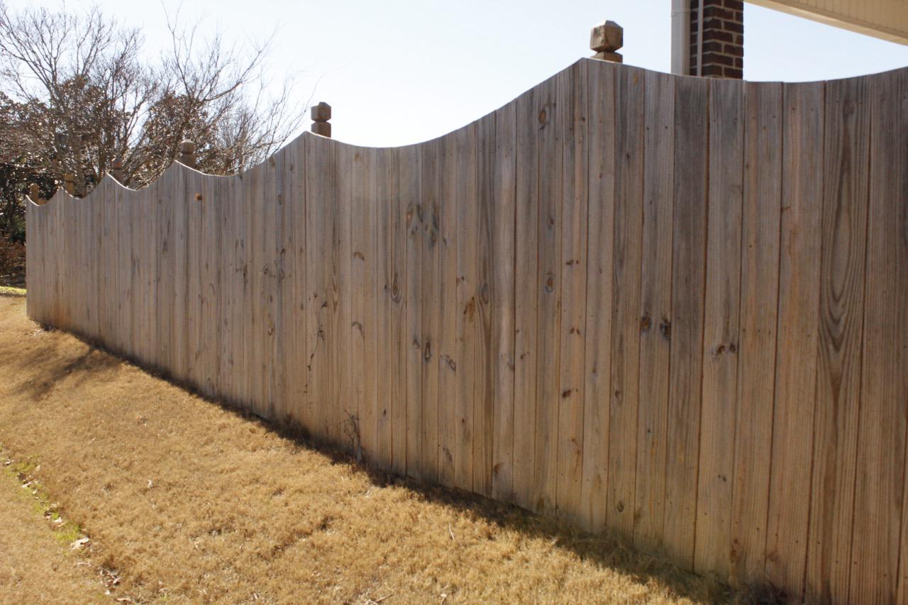 wood scalloped fence installed by top rail fence